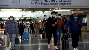 Travelers walk with their luggage at Beijing Capital International Airport in Beijing, China, December 27, 2022. Photo by Reuters/Tingshu Wang